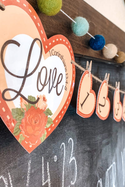 This year I'm using Valentine's Day to teach my kids about Christ's love with this cute Valentine's Day countdown banner! #ValentinesDay #Countdown #1Corinthians #loveispatient #christianhomeschool #kidsbibleactivity #bibleprintable