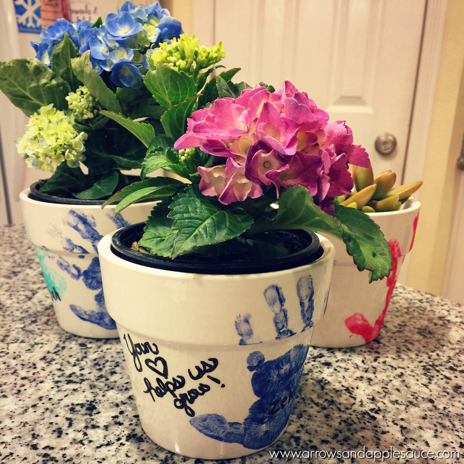 These fun hand print flower pots are easy to make with your kids, and make the perfect Mother's Day gifts. They are sure to become beloved keepsakes. #mothersday #handprint #kidscrafts #keepsakes #flowerpot #homemadegift #handprintcrafts #DIY #madewithlove #momlife #crafttime
