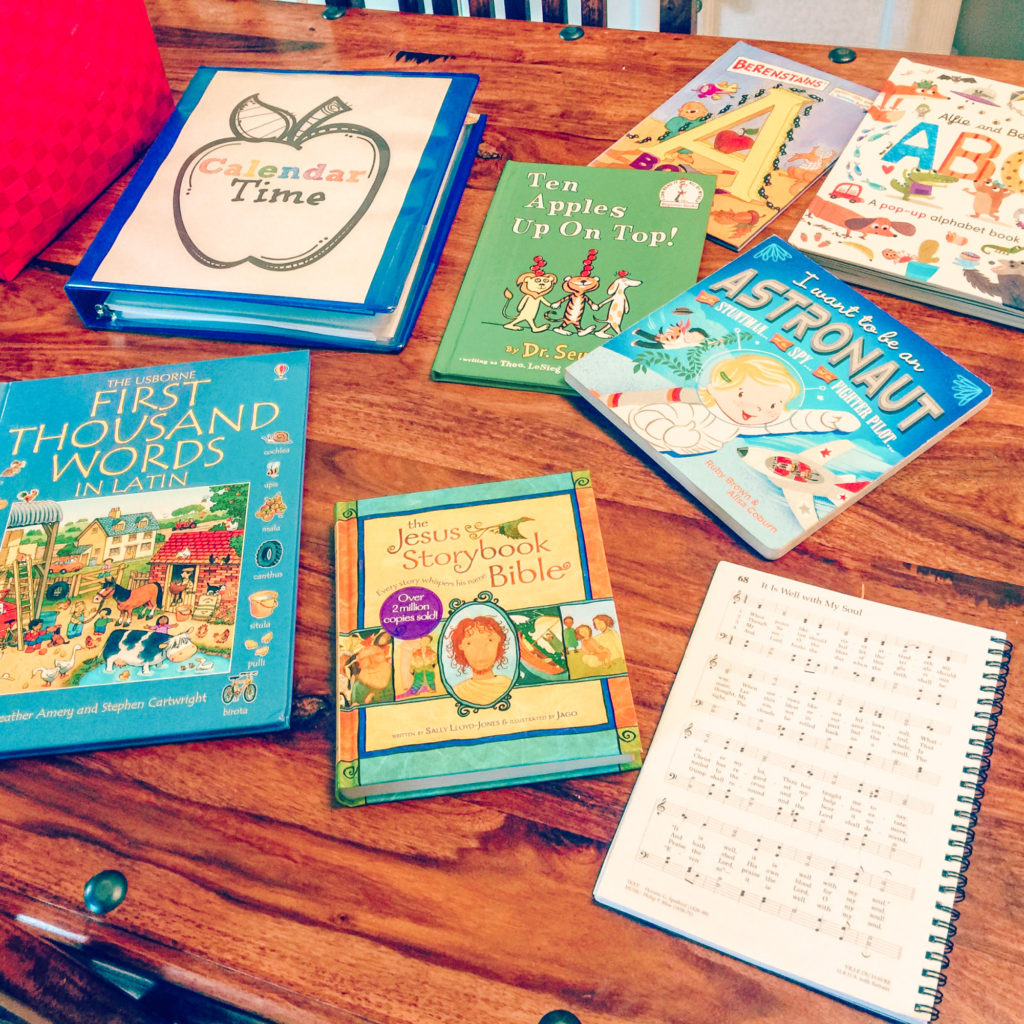 We're making school a little cozier by starting our day with our preschool morning basket. See how we're incorporating reading, singing, and daily learning into one easy to use basket. And staying in our pjs while we do it! #morningbasket #morningroutine #preschoolathome #kidsactivities #hymnswithkids #circletime #homeschool #calendartime #hyggehomeschool