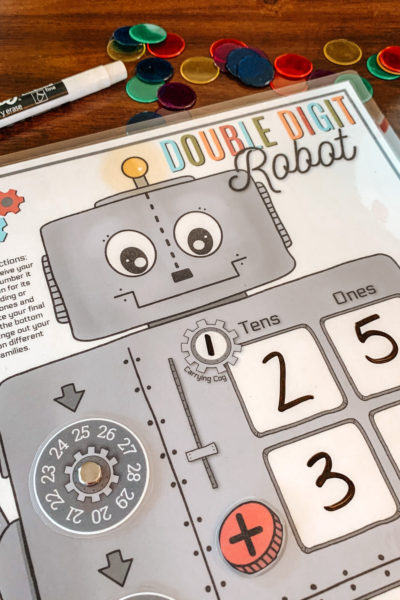 We loving using our Double Digit Robot for addition and subtraction practice! He's perfect for independent math lessons and review! #firstgrademath #doubledigitadding #subtractionpractice #homeschoolprintable #homeeducation #handsonmath #mathmanipulatives #robotmath